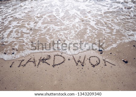 Let's holiday and go to the sea concept. Hard work word on sand wash by wave ocean beach.