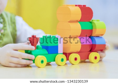 Children's locomotive with wagons, on a wooden background.  train is on the table
