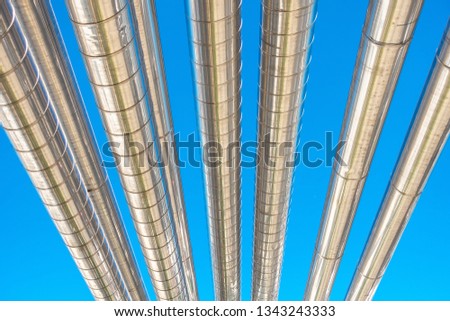 Cooling Chiller or Steam Pipeline and Insulation of Manufacturing in Oil and Gas Industrial, Petrochemical Distribution Pipe at Refinery Plant. Overhead Steel Piping Isolated Blue Sky Background.