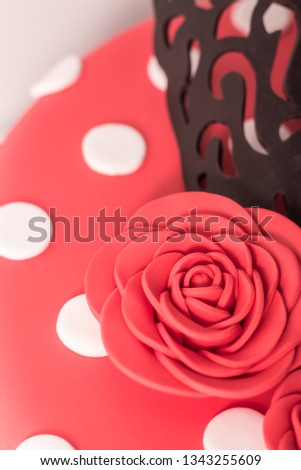red rose of sugar. Fondant cake with white polka dots and comb. Flamenco cake decorated typical. Spain.