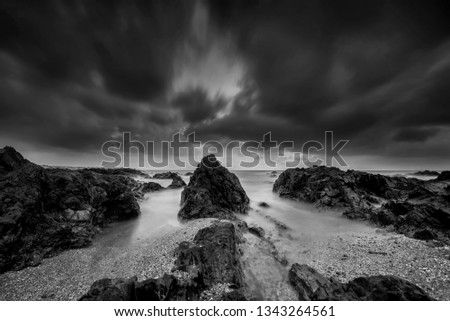 Black & White rocky seascape scene.Beautiful long exposure seascape, rocky beach in black and white
