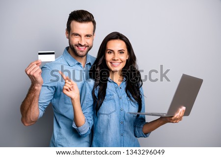 Close up photo beautiful amazing she her he him his couple lady guy hold credit card notebook show simple way internet buy pay  wear casual jeans denim shirts outfit clothes isolated grey background