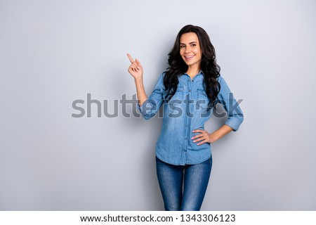 Close up photo amazing beautiful her she lady hold index finger up empty space indicate direct wave wealth hair styling shoulders wear casual jeans denim shirt clothes outfit isolated grey background