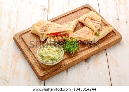 fresh and healthy club sandwich pita bread roll on white wooden background