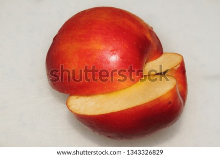 Close up of Rotten Fuji Apple slice in half, with a depth of focus and the top half of the apple on top of the lower half of the apple in the center of the image from a bird eye view.