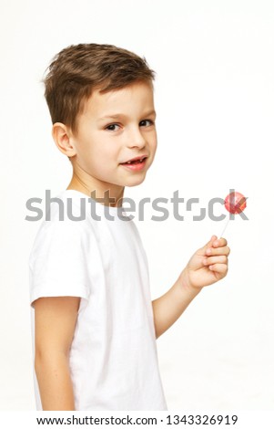 little beautiful boy with a lollipop on a white background 