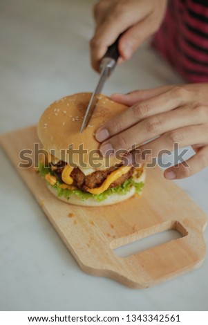 Eating Delicious Burger with Cheese
