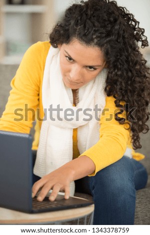 woman on a sofa with laptop