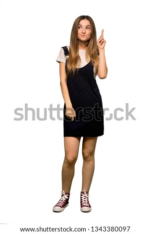 Full body Young pretty woman with fingers crossing and wishing the best on isolated background