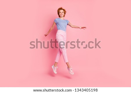 Full length body size view of her she nice cute charming attractive winsome lovely cheerful cheery feminine girl wearing casual walking on air having fun isolated on pink pastel background