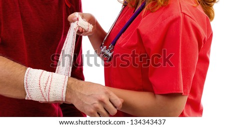 Nurse putting  a bandage to a injured hand on white background. Closeup