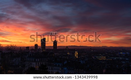 Sunrise in the cloudy sky of Lyon (France). View on its towers.
