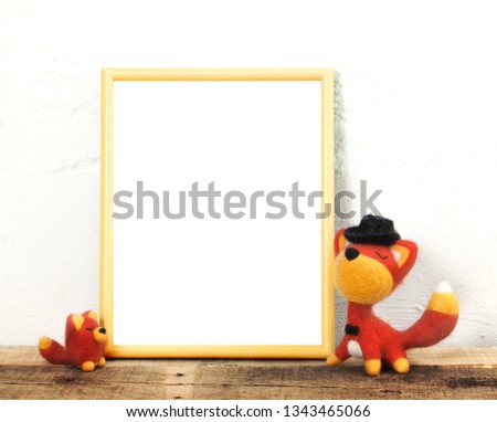 Fun frame mockup for nursery or kids room art. Display your art in the frame. Yellow frame mockup with two cute foxes.