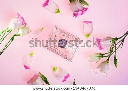 perfume bottles surrounded by flower top view