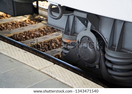 Train wheel close-up with large spring.