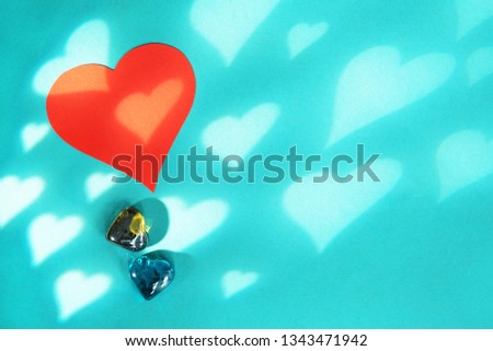 Blue background with red hearts. Gobo mask light effect in the shape of a heart. Valentine's day concept card.