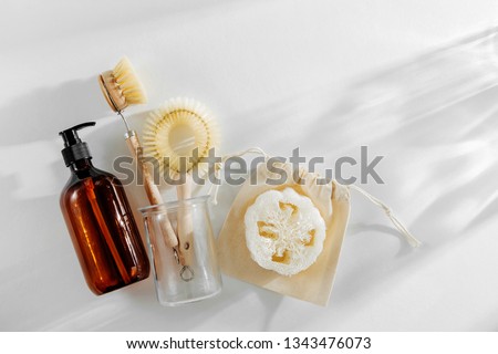 Eco friendly natural cleaning tools and products, bamboo dish brushes and soap dispenser on white background. Zero waste concept. Plastic free. Flat lay, top view