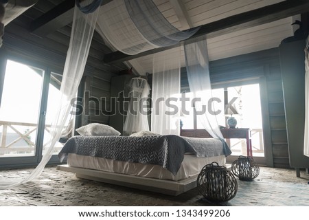 Wedding interior. Charges the bride at the hotel. Wedding photography. The bride's dress hangs near the window. loft style, bride fees. Morning Bride Fees