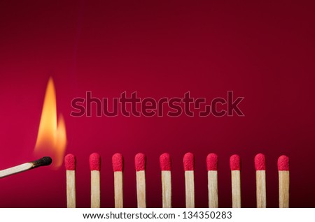 Burning match setting fire to its neighbors, a metaphor for ideas and inspiration Royalty-Free Stock Photo #134350283