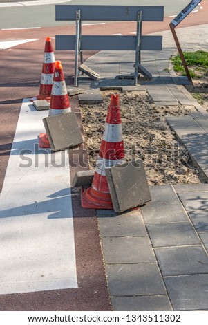 plastic road barrier system placed at a broken pavement