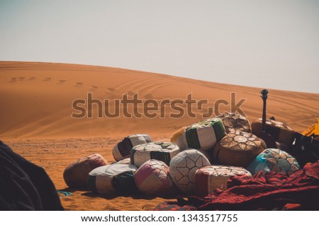 a picture of merzouga desert with ild objects in morocco