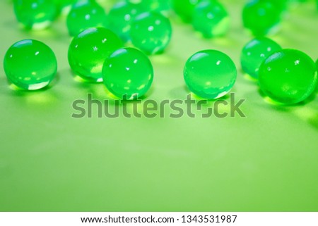 Bright green hydrogel round shape on clean background. Macro gel lime balls. Concept purity and minimalism. Classic abstract spring holiday wallpaper