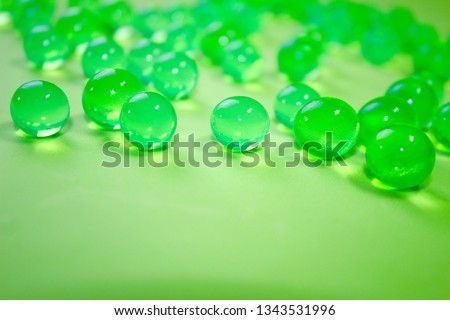 Bright green hydrogel round shape on clean background. Macro gel lime balls. Concept purity and minimalism. Classic abstract spring holiday wallpaper