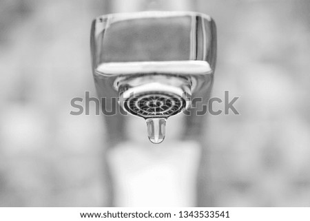 Faucet with dripping water. Tap closeup with dripping water-drop. Water leaking, saving concept