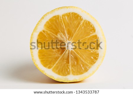 Single half lemon fruit isolated on a white, clean background. Front close up view.