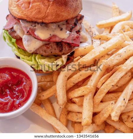 classic burger and french fries with ketchup sauce close up