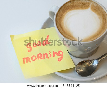  cup of coffee and an inscription  with good morning on a sticker