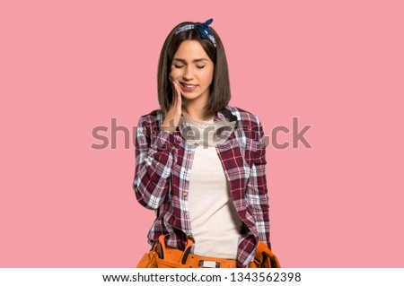 Young worker woman with toothache on isolated pink background