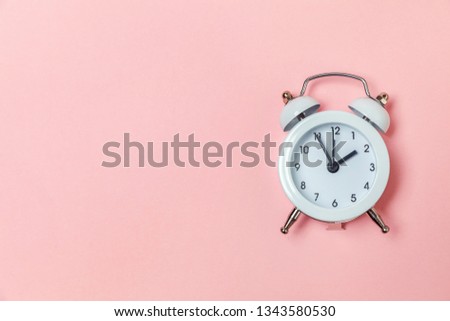 Ringing twin bell vintage classic alarm clock Isolated on pink pastel colorful trendy background. Rest hours time of life good morning night wake up awake concept. Flat lay top view copy space