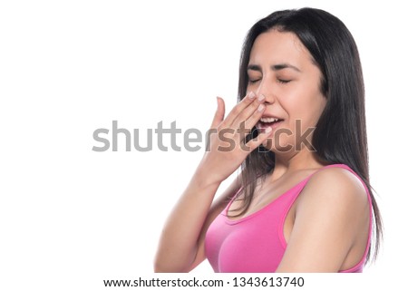 Beautiful sick woman sneezing on white background 