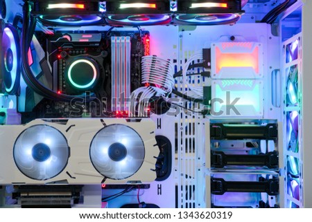 Close-up and inside Desktop PC Gaming and Cooling Fan CPU system with multicolored LED RGB light show status on working mode, interior PC Case technology background