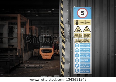 small fork lift and site safety sign on wall