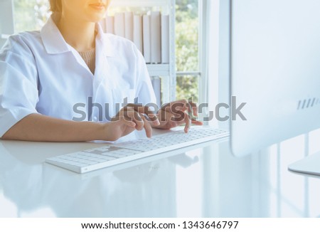 Close up of hands women using computer keyboard on desk in laboratory,Finger typing