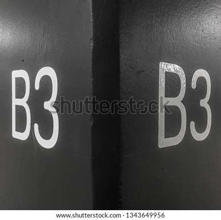 White letters and numbers on a black concrete background wall