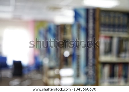 books on bookshelf in library, abstract blur defocused background.