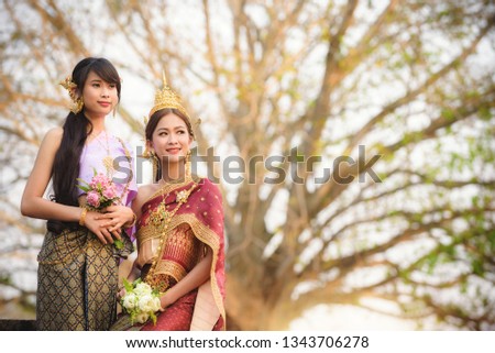 Duo asian young girl thai people is Thai in traditional dress with ancient background in Thailand.
