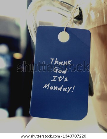 A blue tag hanging with a coffee cup , with text THANK GOD ITS MONDAY,concept of starting good working weekday, enjoy office life