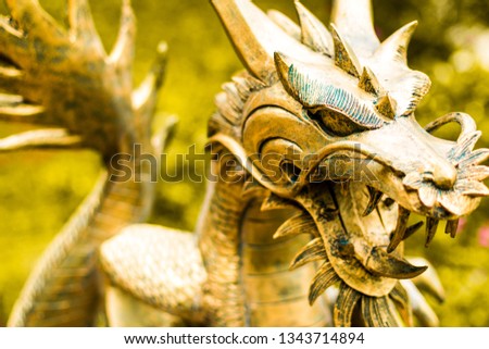 
Statue of chinese golden metal dragon in natural light