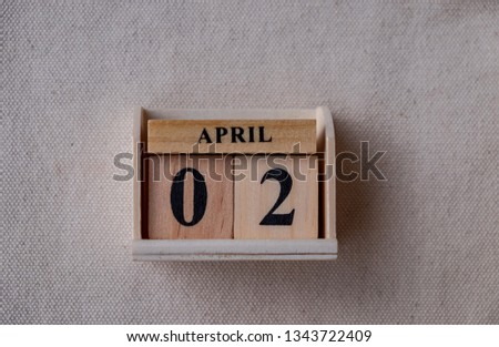 April 2nd. Image of April 2 wooden color calendar on white canvas background. empty space for text 