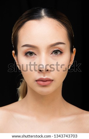 Asian Woman after applying make up black blonde hair style. no retouch, fresh face with acne, lips, eyes, cheek, nice smooth skin. Studio lighting dark background, for aesthetics therapy treatment