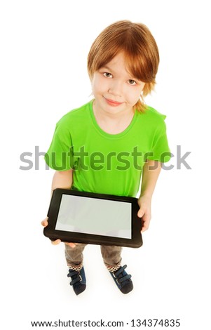 Happy Caucasian 9 years old boy in green shirt top view, holding digital tablet, isolated on white