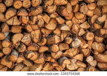 A stack of firewood in preparation for the winter image for background use with copy space
