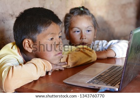 Serious native american kids using notebook. Royalty-Free Stock Photo #1343760770