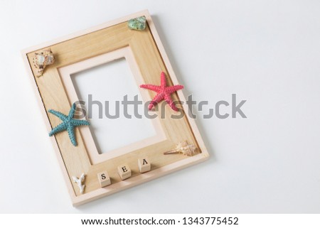 on white background photo frame, starfish, seashells, the word sea. Background about summer vacation, memories
