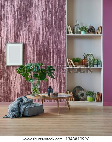Room, wall, claret red background, decorative stone wall concept, modern book shelf and table in the room. Carpet chair vase of plant and middle table. Royalty-Free Stock Photo #1343810996