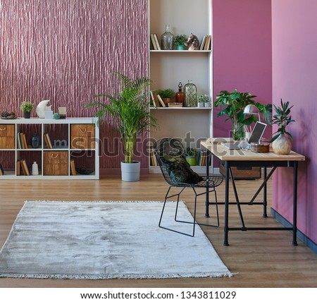 Room, wall, claret red background, decorative stone wall concept, modern book shelf and table in the room. Carpet chair vase of plant and middle table. Royalty-Free Stock Photo #1343811029